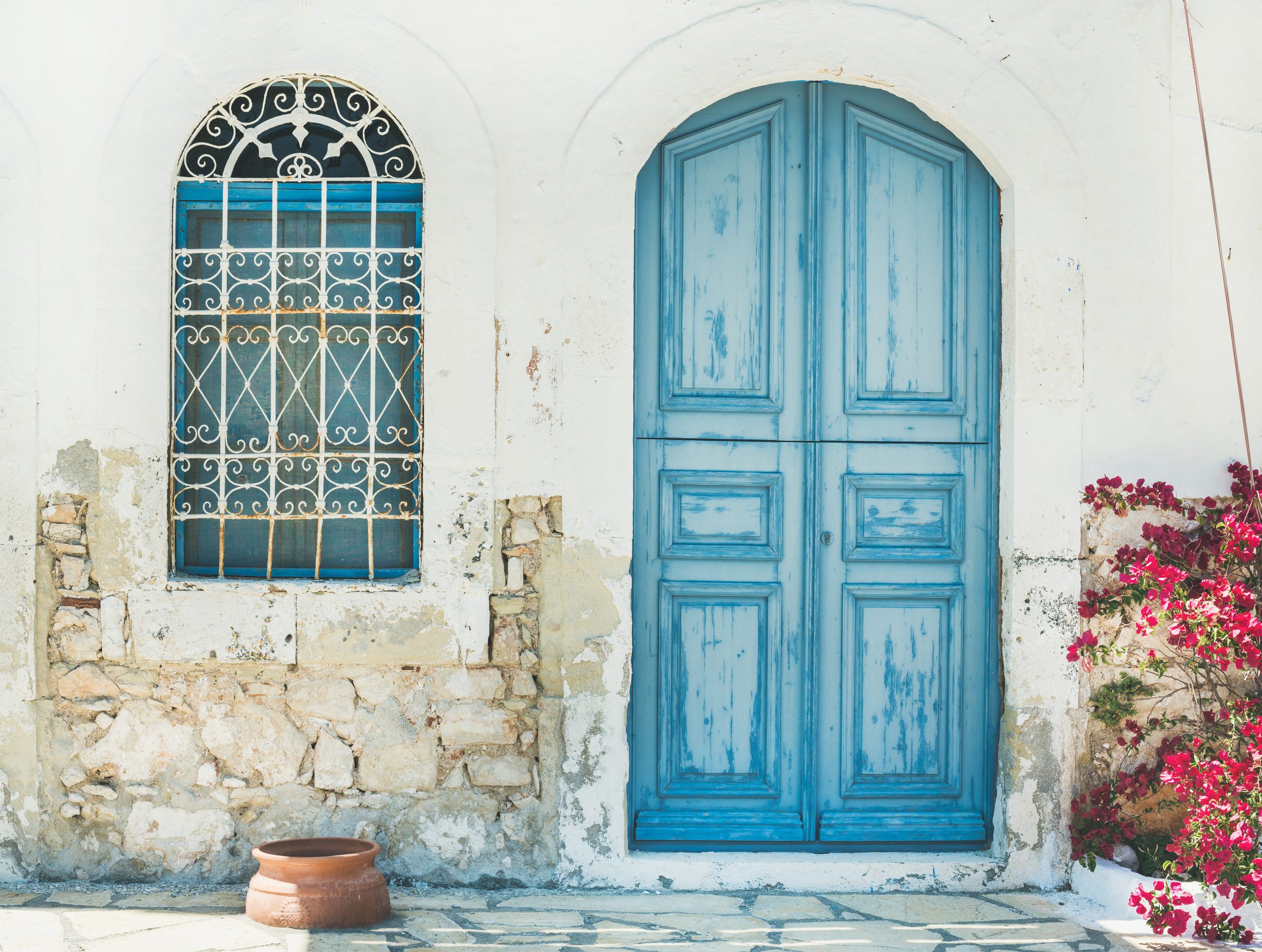 Typical exterior of Greek traditional town street with colorful buildings and marine blue door on Kastelorizo Island, Dodecanese, Greece, Europe